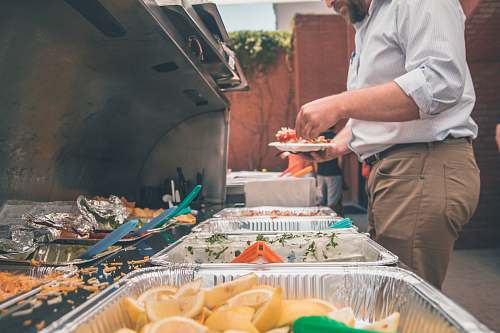 human man picking foods on trays people