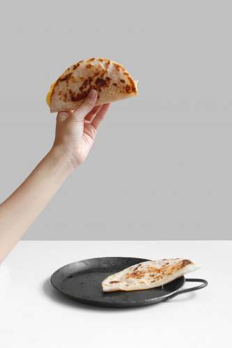 human person holding pancake raising it up food