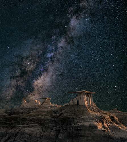 night brown mountain under starry sky galaxy