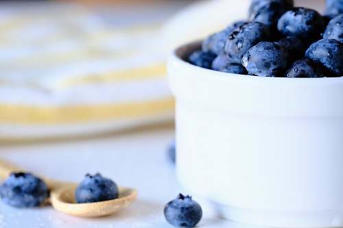 food white ceramic bowl with blue berries fruit