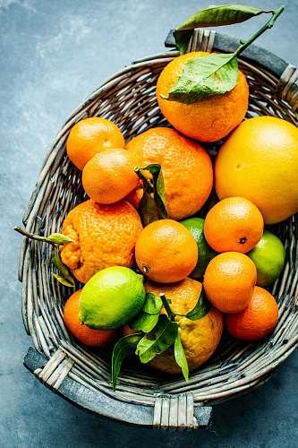 fruit orange and lemon fruits on gray wicker basket citrus fruit