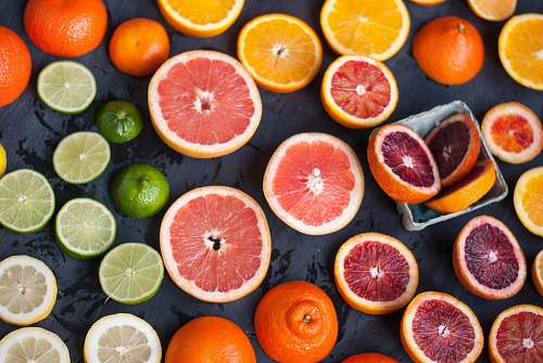 fruit sliced orange fruits on black surface citrus fruit