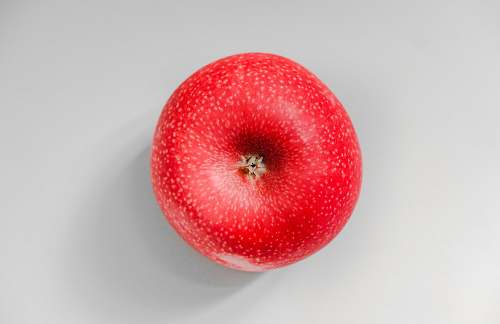 food red apple fruit on white surface Apple