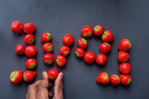 food red strawberries on persons feet plant