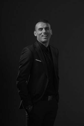 apparel grayscale photography of man wearing black tuxedo suit