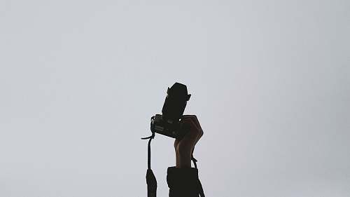 photo person holding camera photography
