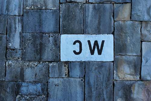 brick WC text on white brick sign