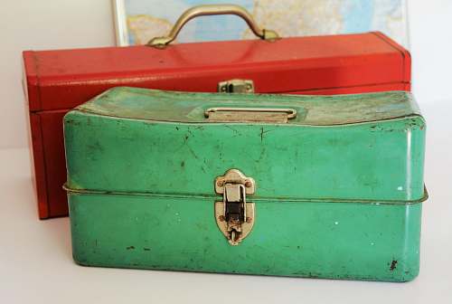 toolbox two rectangular green and red tool cases on white surface metal worker