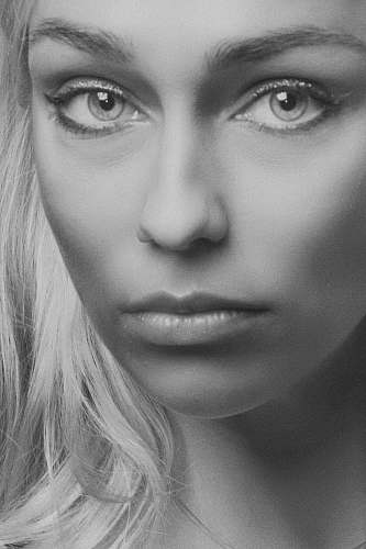 person grayscale photo of a woman black-and-white