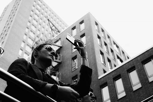 person grayscale photography of woman taking selfie black-and-white