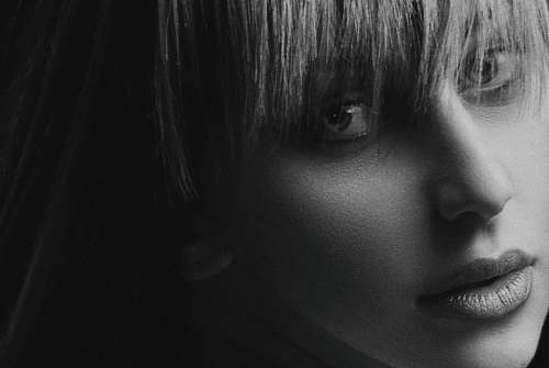 black-and-white greyscale photo of woman with bangs face