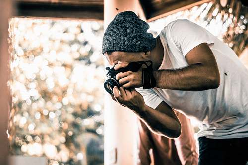 person man holding camera during daytime photographer