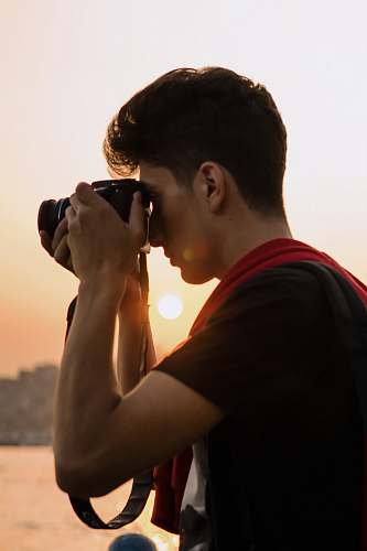 person man holding DSLR camera photo