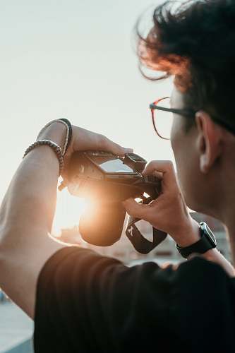person man with grey digital camera photography