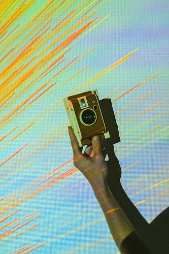 person person showing brown and white vintage camera photographer