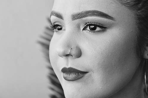 black-and-white shallow focus photo of woman wearing nose hoop face
