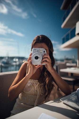 person sitting woman using camera camera