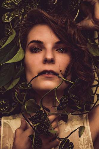person woman beside plants face