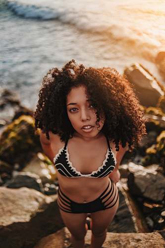 person woman in black bikini near hair