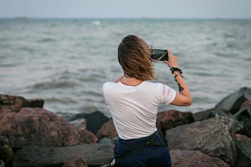 person woman using smartphone photographer