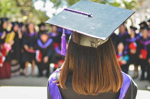person woman wearing academic cap and dress selective focus photography graduation