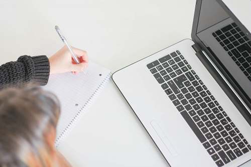 computer woman writing on notebook work