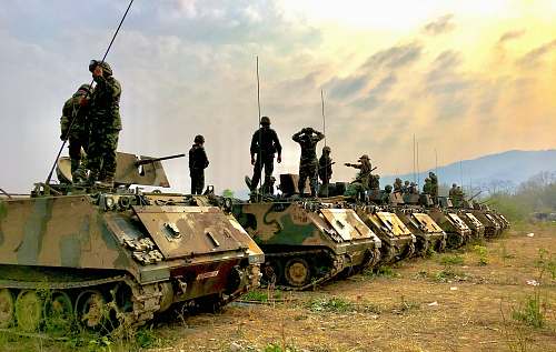 tank soldiers on top of battle tanks army