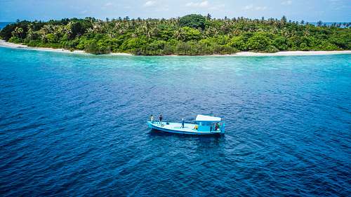 outdoors white boat on body of water during daytime land