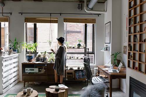 home woman standing near brown wooden cabinet interior