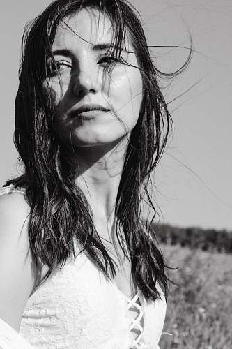 black-and-white grayscale photography of woman standing and facing her right side face