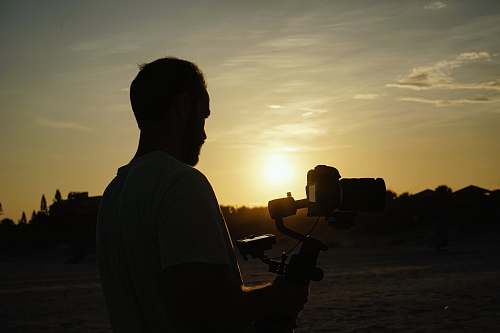 human man holding camera light