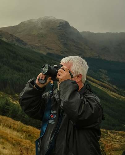 human man taking pictures with camera camera