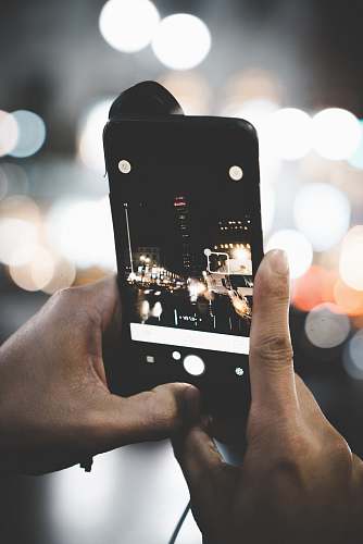 electronics person taking photo using post-2014 iPhone cell phone