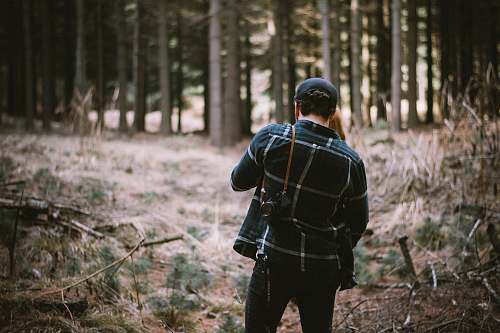 vegetation man standing in forest forest