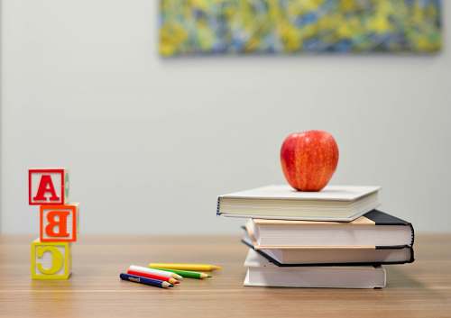 book red apple fruit on four pyle books education