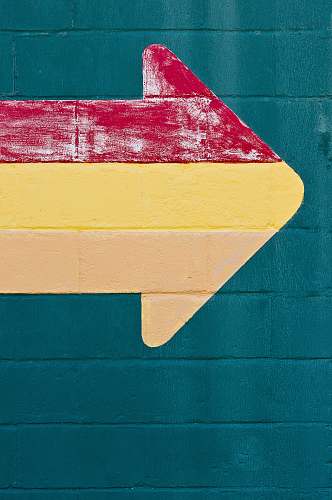 color red, orange, and yellow arrow signage wall