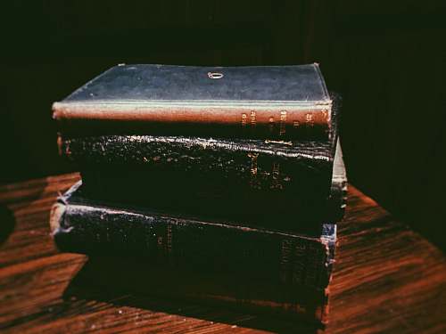 box brown hard covered book on table hardwood