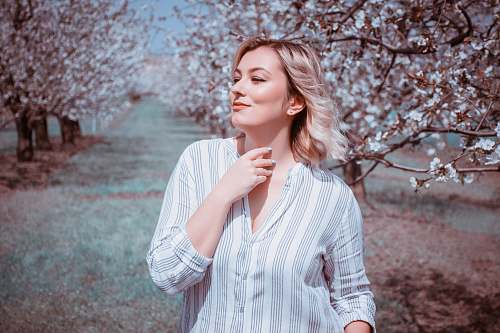 human woman surrounded by trees at daytime people