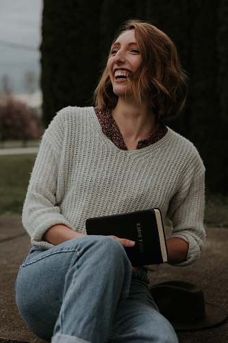 apparel smiling woman wearing white knit sweater sweater
