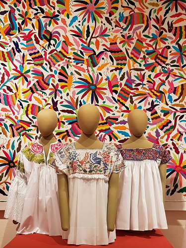 apparel three mannequins on red surface dress