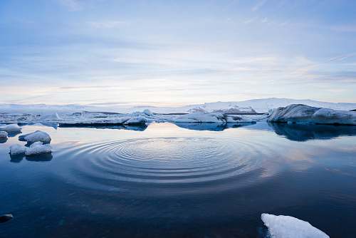 snow body of water between icebergs iceland