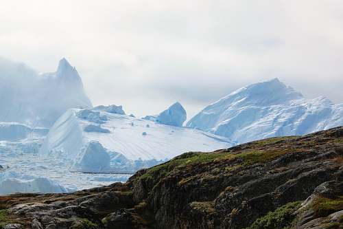 ice glacier near gray rock formation mountain
