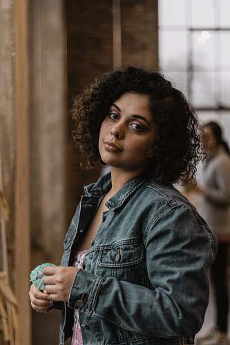 person portrait photography of woman wearing blue denim jacket hair