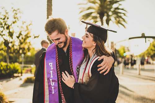people woman hugging man beside her graduation