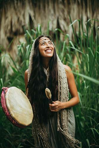 person woman playing drum during daytime close-up photography drum