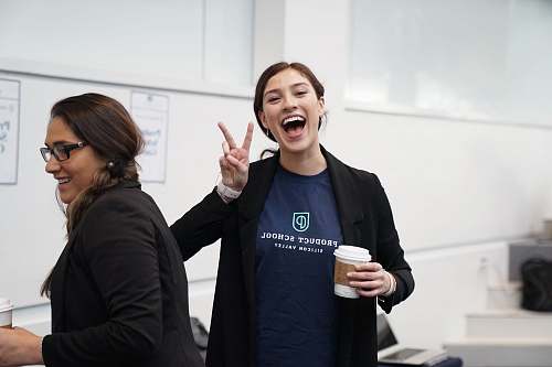 person woman wearing suit making hand peace sign clothing