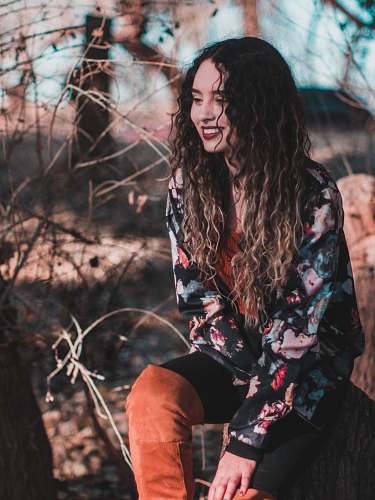 human photo of sitting woman surrounded with twigs people