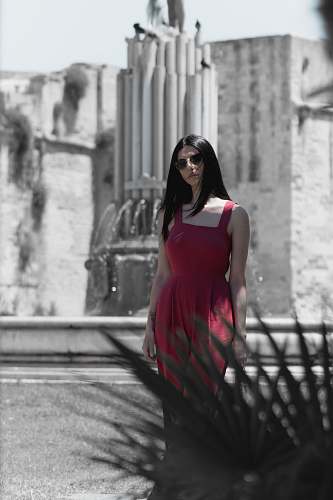 clothing selective focus photography of woman wearing red sleeveless dress evening dress