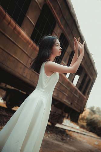 clothing shallow focus photo of woman in white sleeveless dress evening dress
