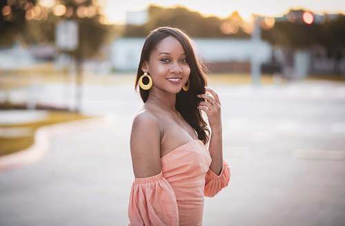 clothing smiling woman in beige tube dress looking over left shoulder robe